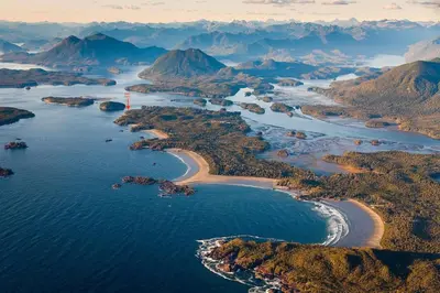an aerial view of a river with mountains at Marielles Lookout - Your Oceanfront Escape Framed by Forest & Waves in Tofino