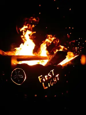 a fire pit with a persons hand and a lost light sign at First Light - Vintage waterfront with hot tub - One Bedroom in Tofino