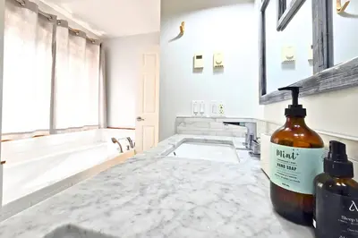 a bathroom with a bottle of whiskey on a counter at Cedar and Salt in Tofino