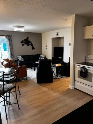 a living room with a dolphin on the wall at Jaspers Seaside Resort complex, in Courtenay