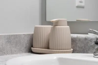 two vases sitting on a counter next to a sink at The Cabin Sleep in Edmonton