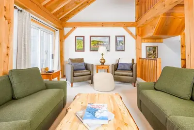 a living room with two couches and a coffee table at Alpine Timbers 2 Luxury Chalet with Hot Tub in Big White