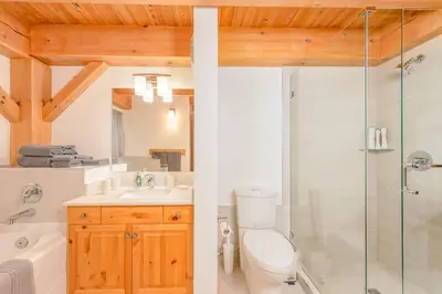 a bathroom with a toilet sink and a shower at Alpine Timbers 2 Luxury Chalet with Hot Tub in Big White