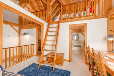 a room with a loft bed and a desk and a ladder at Alpine Timbers 2 Luxury Chalet with Hot Tub in Big White