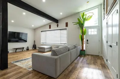a living room with a couch and a window at Edmonton Home in Edmonton