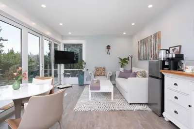 a living room with a couch and a table at Luxury Modern 2-Bedroom Suite Near Transit & Shops in White Rock
