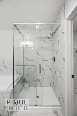 a shower with a glass enclosure in a bathroom at NEW - Modern Escape - KingBed - Fireplace - Garage - Netflix in Edmonton