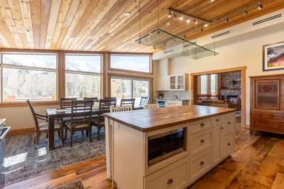 a kitchen and dining room with a table and chairs at Elk River Estate by Fernie Central Reservations in Fernie