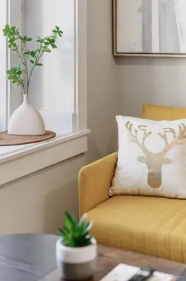 a living room with a yellow chair and a pillow at Private Entrance Suite Near Deer Lake & Metro in Burnaby