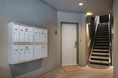 a hallway with lockers and a staircase in a house at 2BR + Sofabed | Gables | Epic Village Location | Secure Parking | Stylish & Cozy in Whistler