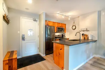 a kitchen with a counter top and a refrigerator at 1BR+Sofabed | Deer Lodge | Epic Village Location | Covered Patio | Ski Locker | Fireplace | Parking in Whistler