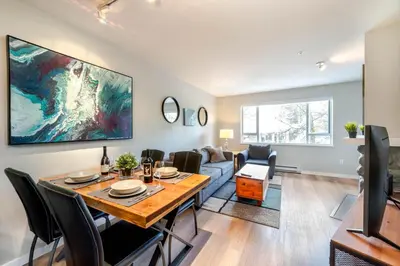 a living room with a dining table and a couch at 1BR+Sofabed | Deer Lodge | Epic Village Location | Covered Patio | Ski Locker | Fireplace | Parking in Whistler
