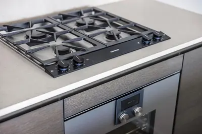 a stove top oven sitting on top of a kitchen counter at Modern Brand New 1-Bedroom Condo in Downtown in Vancouver