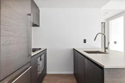 a kitchen with a sink and a counter top at Modern Brand New 1-Bedroom Condo in Downtown in Vancouver