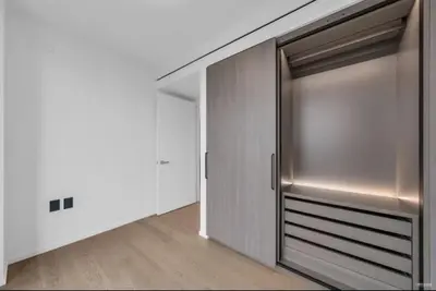 a sliding glass door in a room with a wooden floor at Modern Brand New 1-Bedroom Condo in Downtown in Vancouver