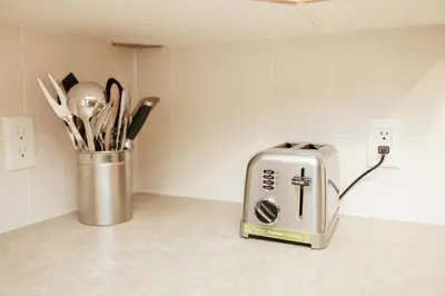 a toaster sitting on a counter in a kitchen at Cozy 2BR-5BD Suite - Mountain Views - Htd Parking in Canmore