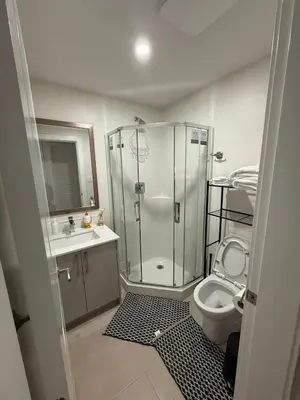 a bathroom with a shower and a toilet and a sink at ideal place in Prince George
