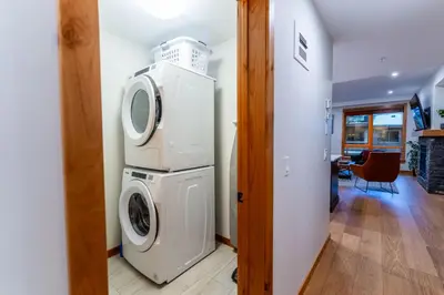 a laundry room with a washer and dryer at Alpine Chic - two-story mtn escape near downtown in Canmore