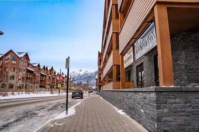 a street in a town with a car parked on the street at Alpine Chic - two-story mtn escape near downtown in Canmore