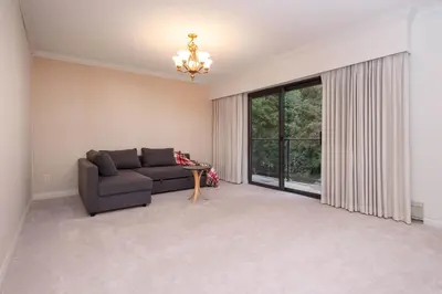 a living room with a couch and a large window at Elegant Cypress Park Villa with Panoramic Ocean View in West Vancouver