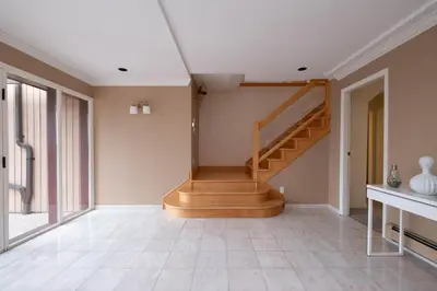 a hallway with a staircase in a house at Elegant Cypress Park Villa with Panoramic Ocean View in West Vancouver