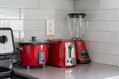 a blender and a toaster sitting on a kitchen counter at Cozy And Modern 2 Bedroom Along Bow River in Downtown in Calgary
