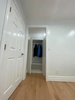 an empty hallway with a white door and a closet at Spacious 2 BED close to BEACH, Highway & US BORDER in Surrey