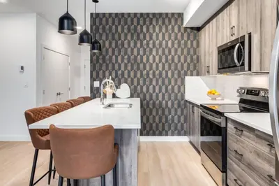 a kitchen with a sink and a counter top at Lovely 3BR unit in the heart of Calgary in Calgary