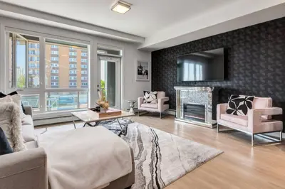a living room with a couch and a fireplace at Modern 3BR unit in the heart of Calgary in Calgary