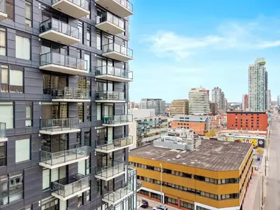 an apartment building with balconies and a city at Modern 1BR City Escape with Balcony near DT Calgary in Calgary