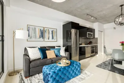 a living room with a couch and a table at Spacious and Stylish Modern Condo in Calgary in Calgary