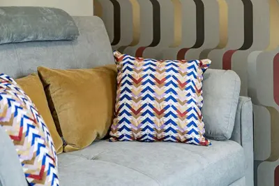 a gray couch with two pillows on it at Cozy and Stylish Stay in Mountain View Condo in Canmore