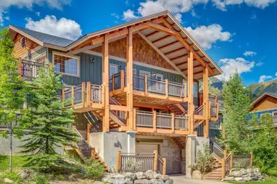 a log home with a wrap around deck at Rockies Escape Skiing Hiking and Private Hot Tub in Golden