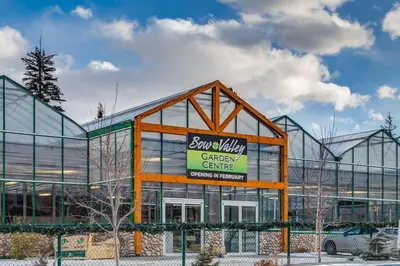 a large glass building with a sign in front of it at Cozy Mountain View Condo Close to DT Canmore in Canmore