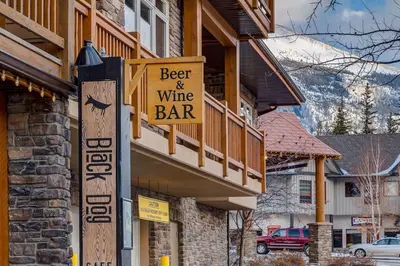 a sign for a beer and wine bar on a building at Cozy Mountain View Condo Close to DT Canmore in Canmore