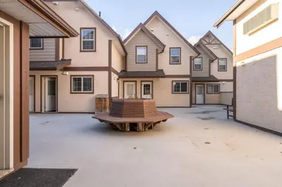 an empty parking lot in front of a house at Cozy Mountain View Condo Close to DT Canmore in Canmore