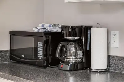 a kitchen counter with a microwave and a roll of paper towels at Cozy getaway for exploring Canmore and Banff in Canmore