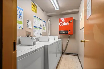 a bathroom with a coke sign on the wall at Cozy getaway for exploring Canmore and Banff in Canmore