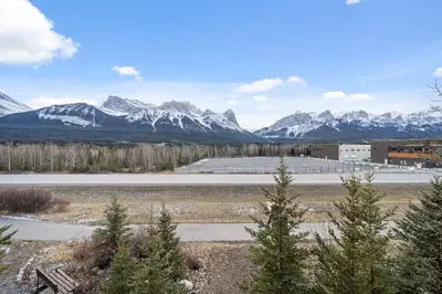 a view of a snowy mountain range with a road at Cozy getaway for exploring Canmore and Banff in Canmore
