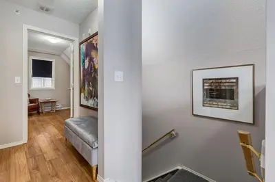a living room with white walls and a gray couch at Cozy getaway for exploring Canmore and Banff in Canmore