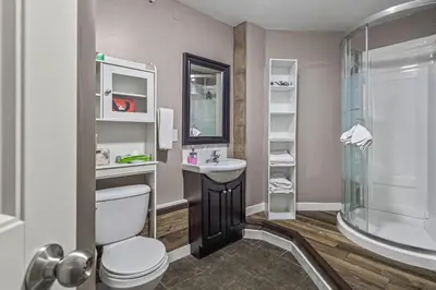 a bathroom with a toilet and a sink and a shower at The Most Perfect Stay in Canmore with Mountain View in Canmore