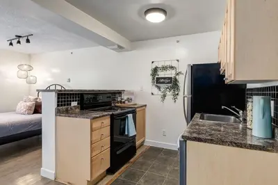 a kitchen with a sink and a stove top oven at The Most Perfect Stay in Canmore with Mountain View in Canmore
