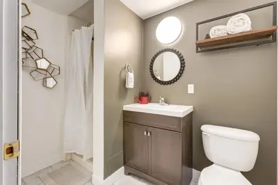 a bathroom with a toilet and a sink and a mirror at Peaceful Mountain Getaway in Canmore near Banff in Canmore
