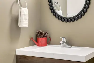 a bathroom with a white sink and a mirror at Peaceful Mountain Getaway in Canmore near Banff in Canmore