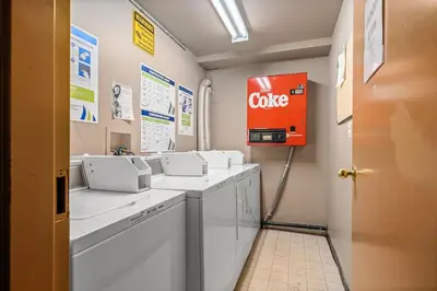 a bathroom with a coke sign on the wall at Peaceful Mountain Getaway in Canmore near Banff in Canmore