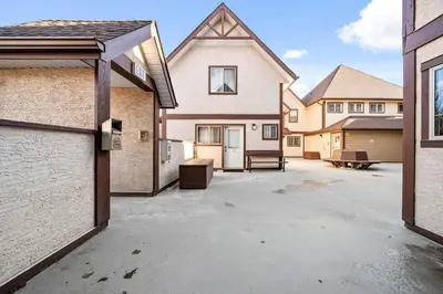 an empty parking lot in front of a house at The Perfect Getaway for Exploring Canmore and Banff) in Canmore