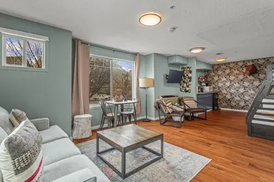 a living room with a couch and a table at Charming and Stylish renovated Condo near Banff in Canmore