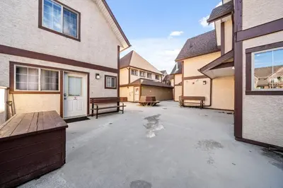 an empty parking lot in front of a house at Cozy Tropical Vibe Haven in Canmore near Banff in Canmore