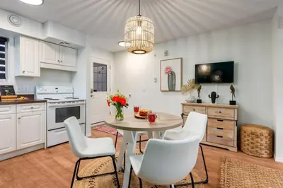 a kitchen with a table and chairs in a kitchen at Cozy Tropical Vibe Haven in Canmore near Banff in Canmore