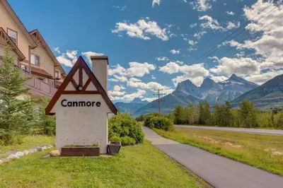 a sign for a campsite next to a road at Cozy Tropical Vibe Haven in Canmore near Banff in Canmore
